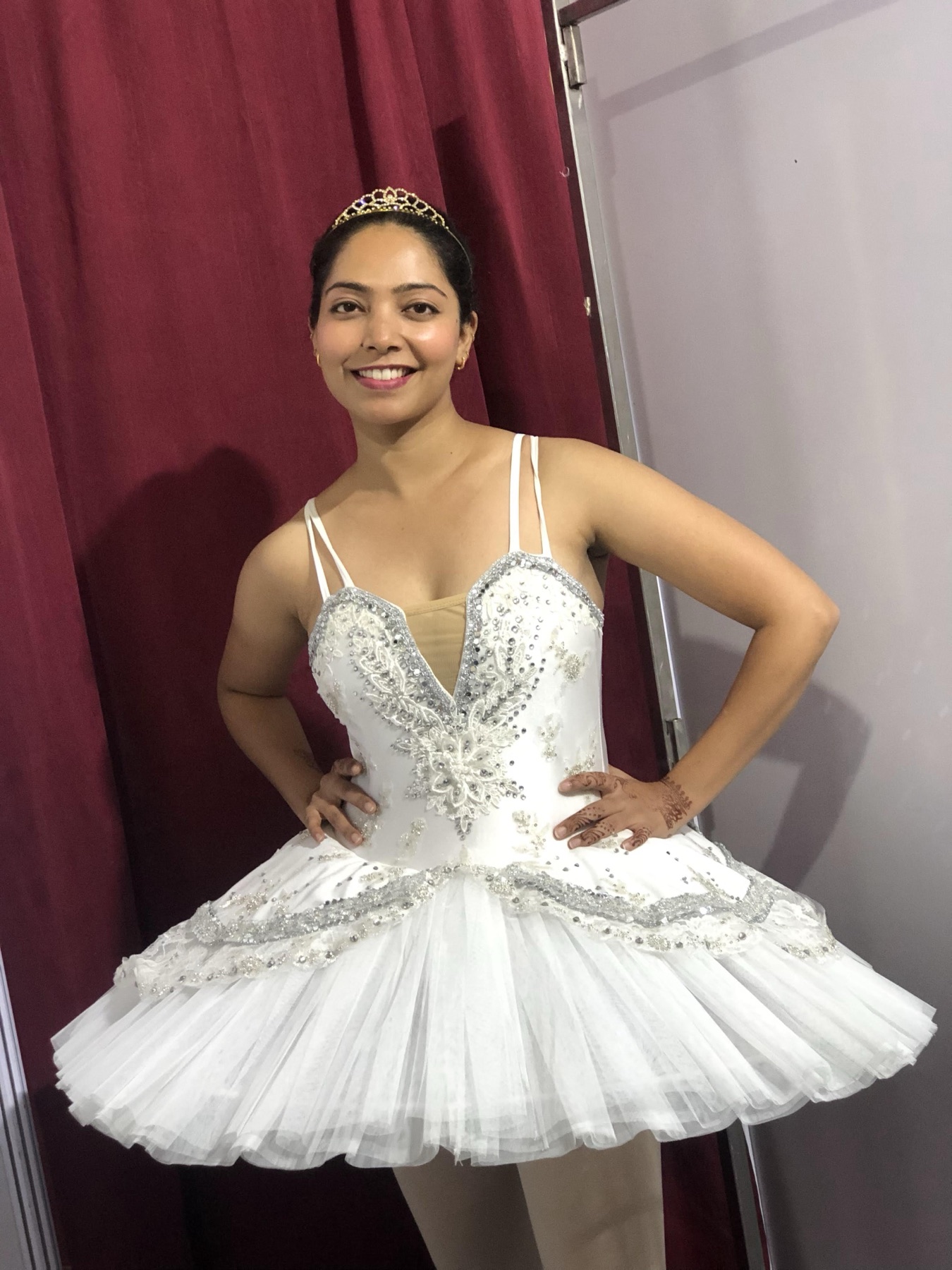 Tapti Jain smiling in a white ballet costume