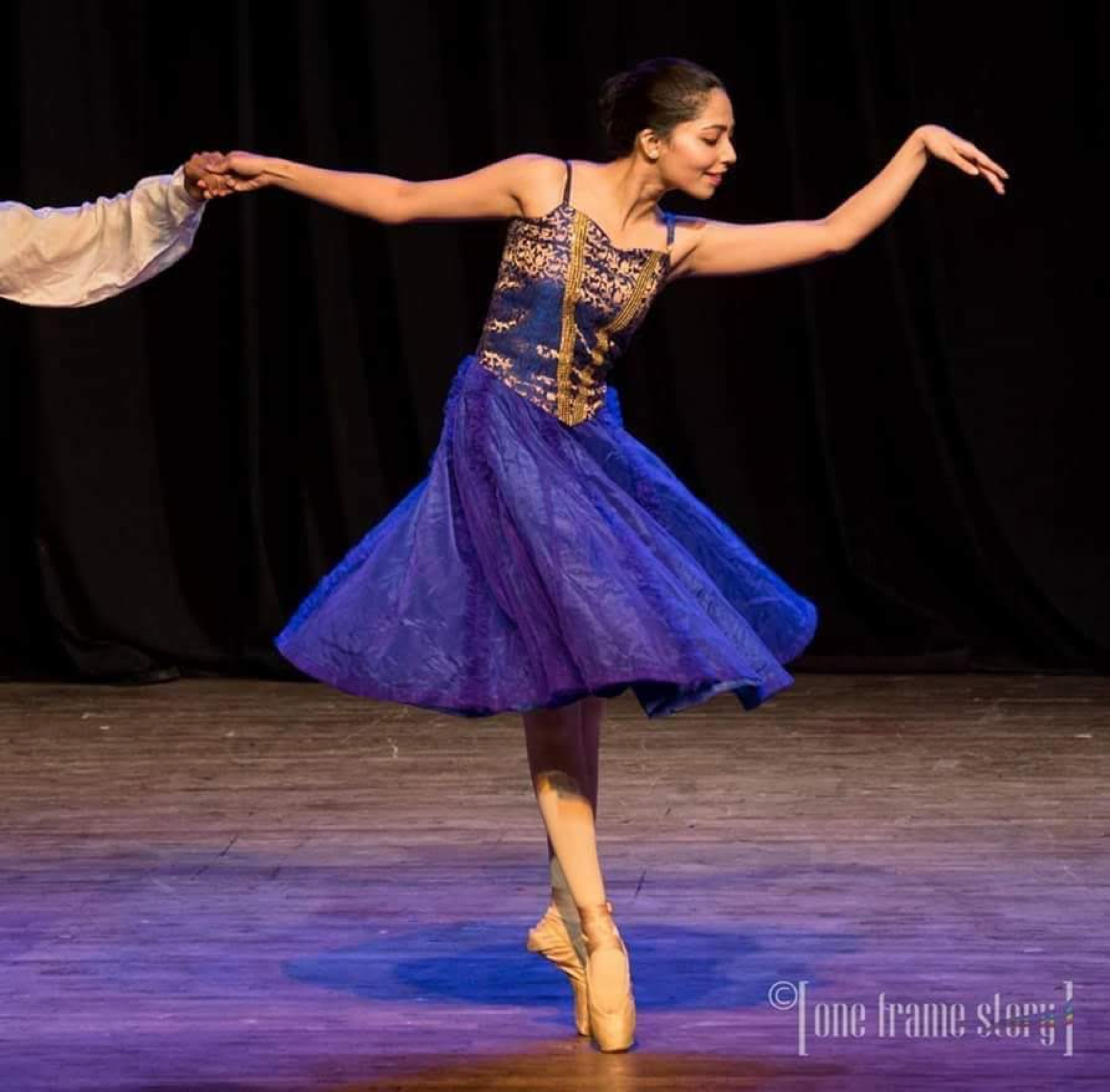 Tapti performing a solo dance in a blue ballet costume